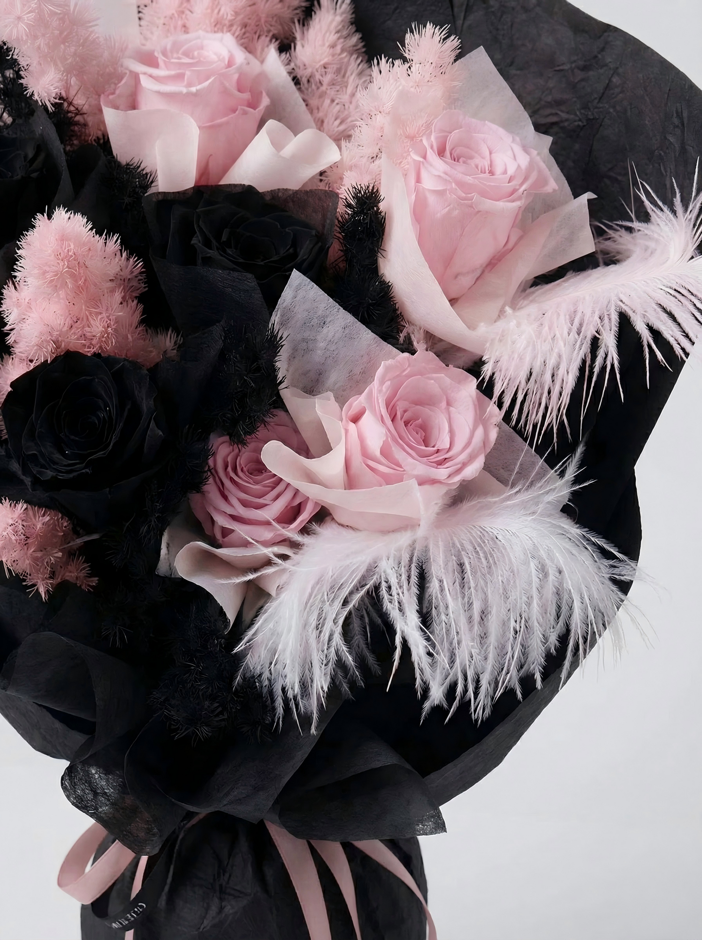 Enchanted Midnight Bloom: Pink & Black Everlasting Rose Arrangement with Feathers